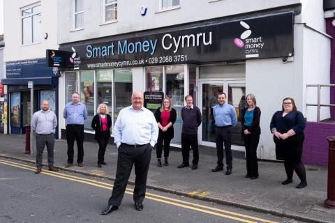 Picture showing the staff of Smart Money Cymru stood outside their office