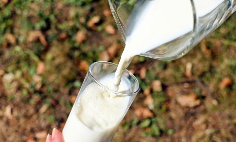A glass of milk being poured