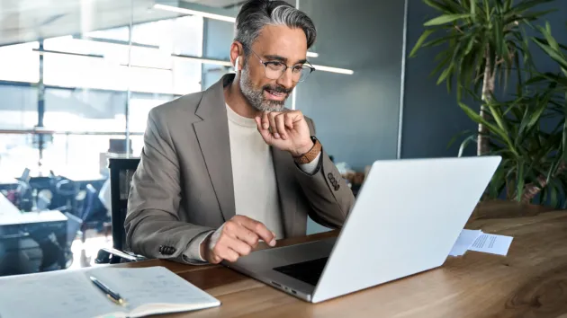 Employer looking at a digital device   