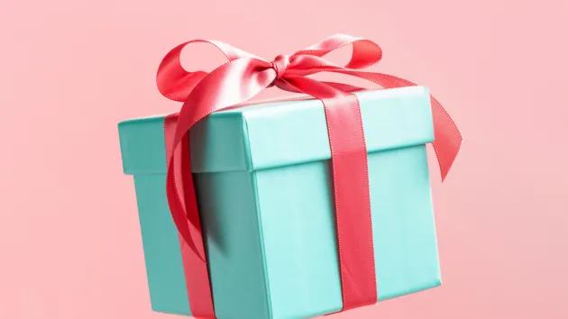 Gift - present wrapped in green paper with a red ribbon