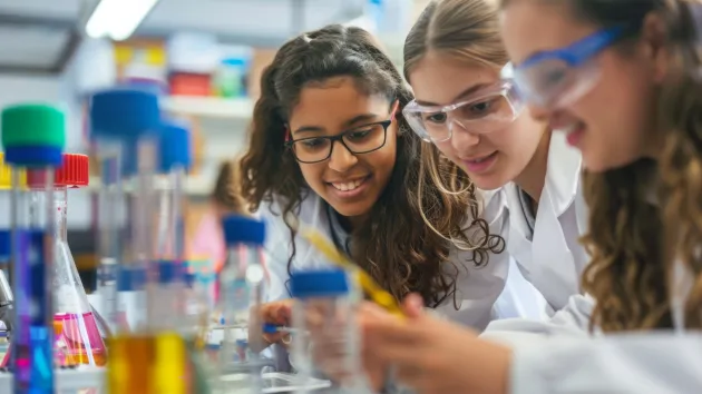 girls in a school science lab working on an experiment 