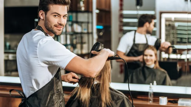 Hair dresser and client in salon