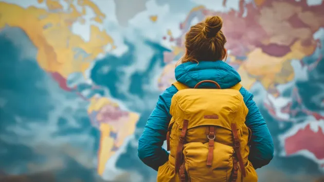 Person stood in front of a map of the world