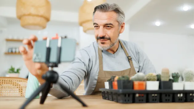 Business owner setting up phone to record promotional content.