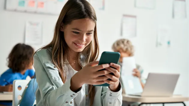 child looking at a mobile phone 