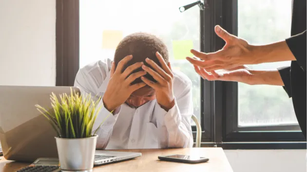 office worker being shouted at by a manager 