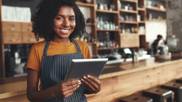 small business owner looking at a digital device