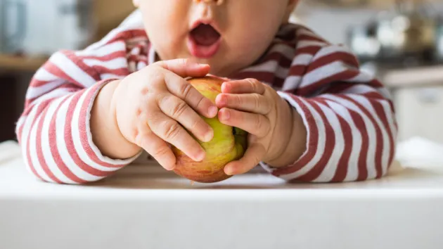 child eating an apple