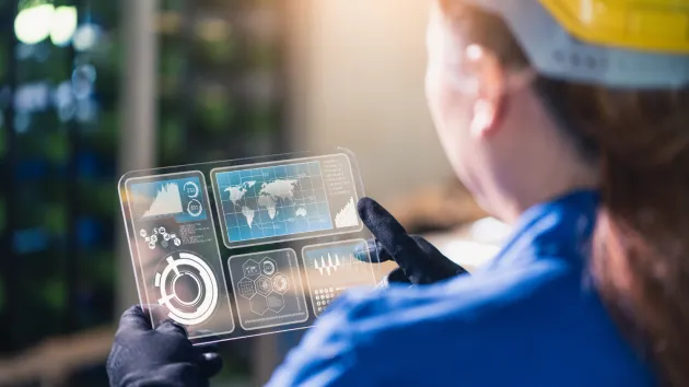 Engineer looking at a digital device 