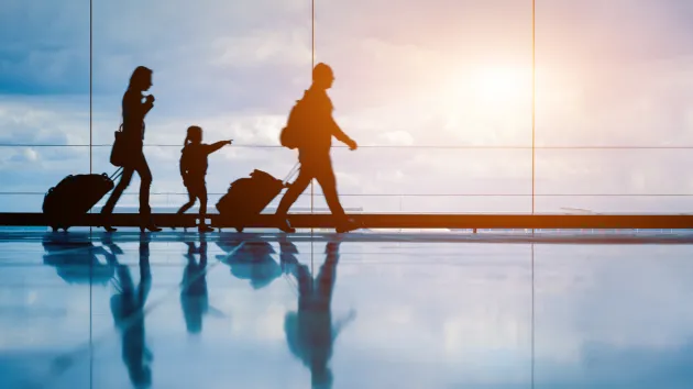 family walking through and airport 