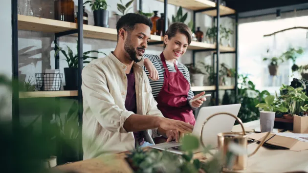 business people working together on a laptop