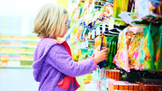 Child picking sweets in a supermarket 