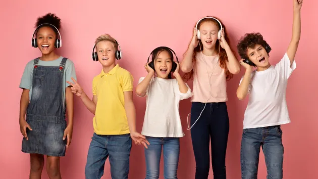 group of children wearing headphones listening to music