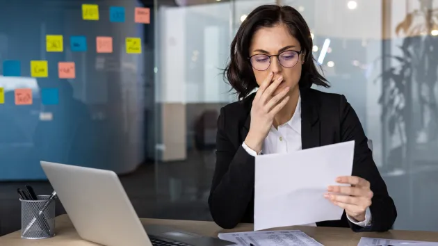 Worried person looking at business accounts 