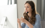 call centre operator in wireless headset talking with customer