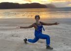 Paula Roberts owner of Happy Yoga on a beach 