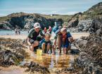 family at a beach looking in rock pools