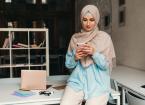 woman in hijab working in office room, education online, remote work freelancer, using smartphone