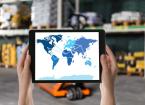 Wholesale trading. Woman tablet with world map illustration at warehouse, closeup