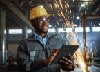 Professional Heavy Industry Engineer Worker Wearing Safety Uniform and Hard Hat Uses Tablet Computer.
