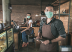 Cafe owner wearing a face mask for COVID-19 protection