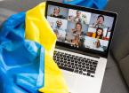 Zoom meeting online with Ukrainian flag draped over a laptop