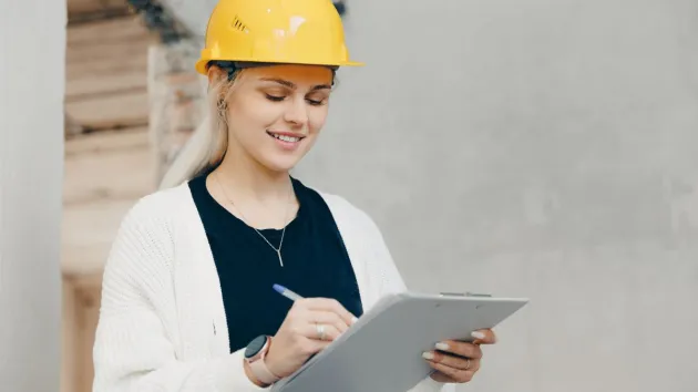 female engineer checking work on a building site 