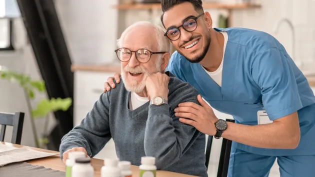 male social care worker with mature client 