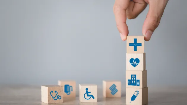 wooden blocks with medical logos - wheelchair, heart, stethoscope 