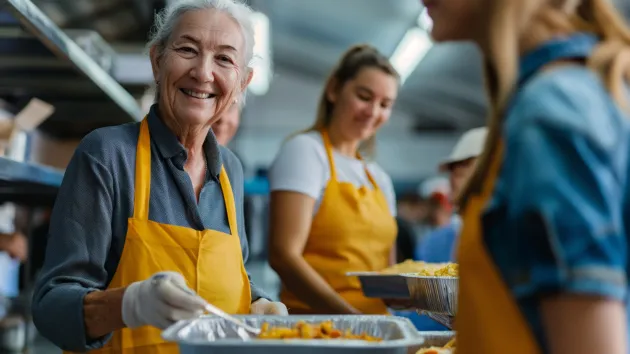 Older person volunteering in a community kitchen