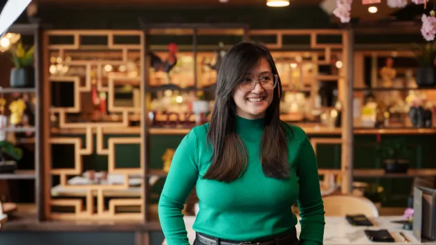 Woman smiling at camera in restaurant