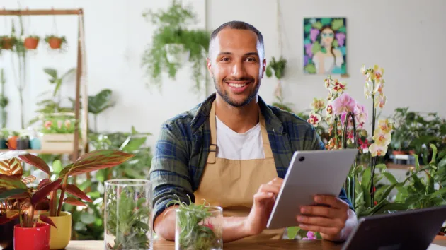 small business owner, florist, using a laptop