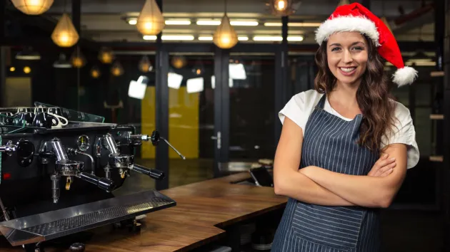 Coffee shop worker wearing a Christmas hat