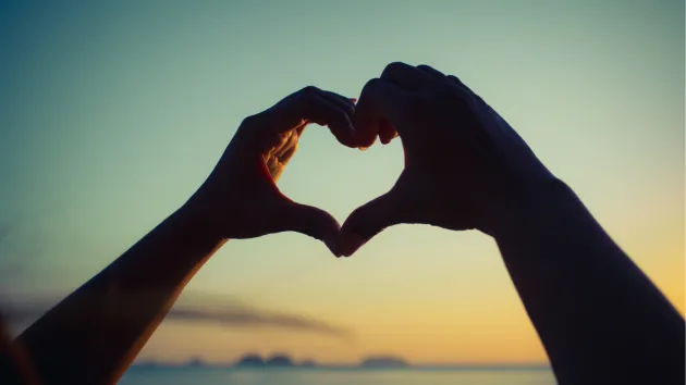 hands making the shape of a heart 