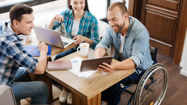 Business meeting - 3 people one of which is a wheelchair user 