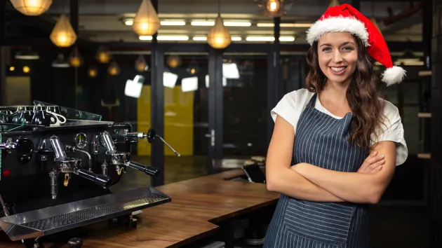 Coffee shop worker wearing a Christmas hat