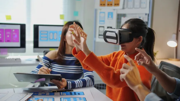 Designers using a VR headset 