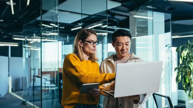 Employer and employee looking at a digital device