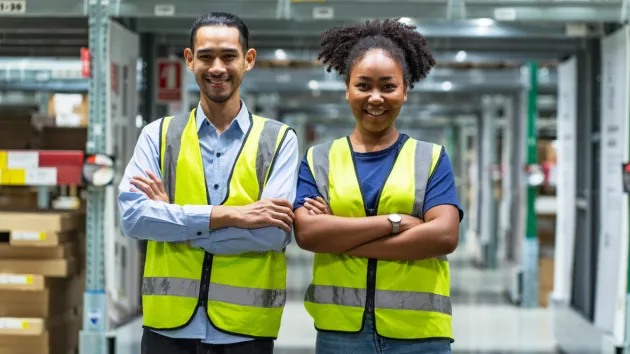 Warehouse workers wearing high visibility clothing 
