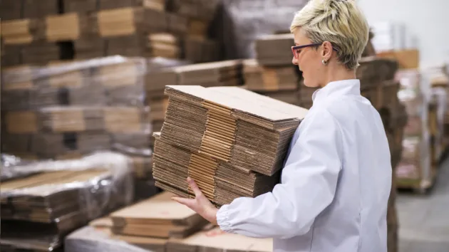 person carrying cardboard 