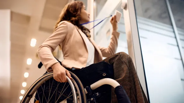 wheelchair user using an ID card to access an office 