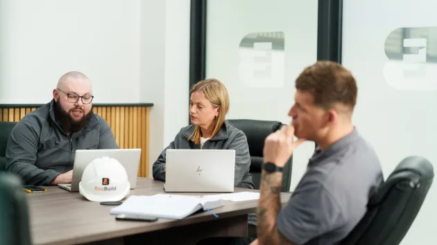 Colleagues discussing at a table 