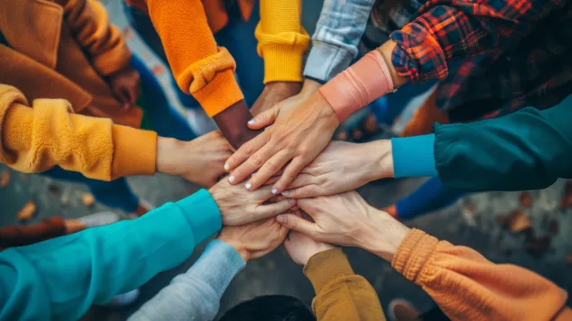 group of volunteers holding hands 