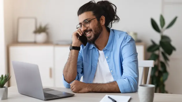 Home worker talking on a phone 