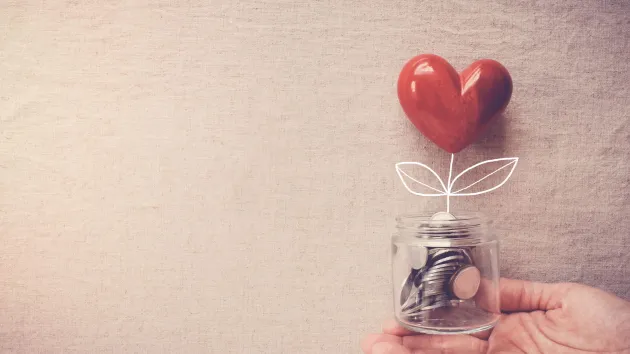 Jar of coins and heart - philanthropy 
