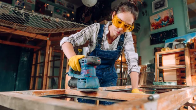 Person upcycling furniture in workshop