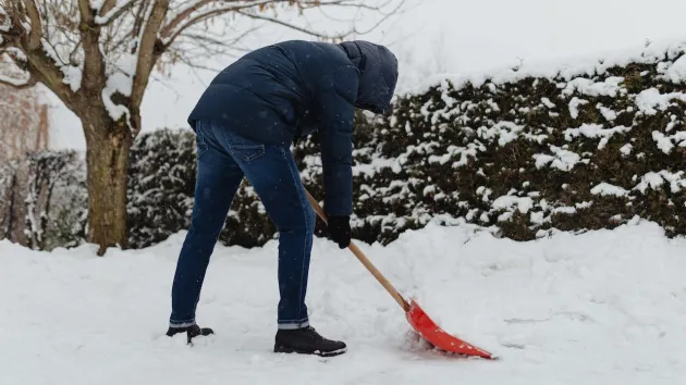 person clearing snow