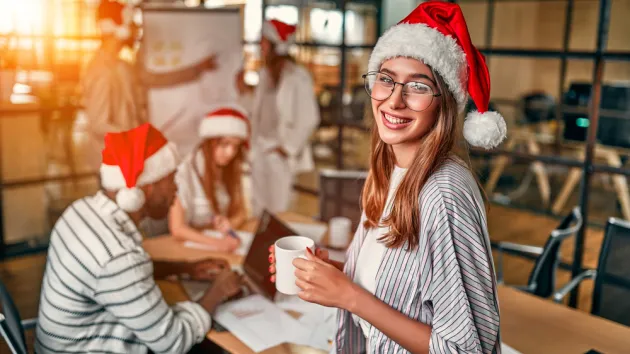 office workers wearing Christmas hats 