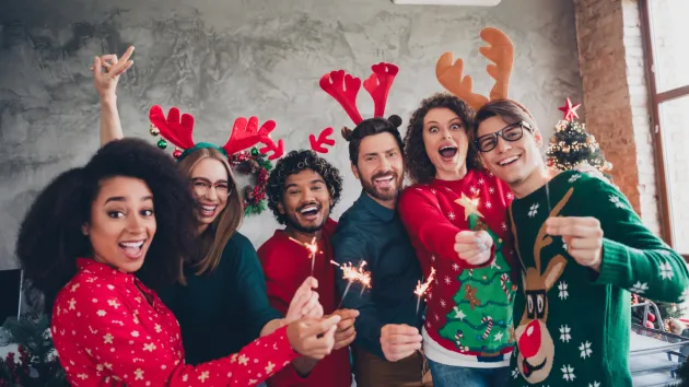 work colleagues wearing Christmas jumpers 