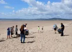 Beach clean - people collecting rubbish from a beach 